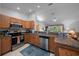 Well-lit kitchen with stainless steel appliances, solid-surface countertops, and a seamless flow to the living area at 6718 Cherry Rd, Ocala, FL 34472