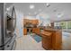 Kitchen with stainless steel appliances, light wood cabinets and a breakfast bar, perfect for casual dining at 6718 Cherry Rd, Ocala, FL 34472