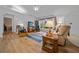 Bright living room with hardwood floors, comfortable seating and a large window providing natural light at 6718 Cherry Rd, Ocala, FL 34472