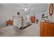 Spacious main bedroom boasts soft carpet, ceiling fan, a decorative bed frame, and ample closet space at 6718 Cherry Rd, Ocala, FL 34472