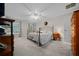 Comfortable main bedroom provides cozy carpeting, decorative bed frame, and lots of natural light at 6718 Cherry Rd, Ocala, FL 34472