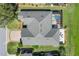 Aerial view of a home featuring a screened pool, manicured landscaping, and a driveway at 6865 Sw 97Th Terrace Rd, Ocala, FL 34481