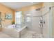A glass shower and soaking tub in the bathroom area at 6865 Sw 97Th Terrace Rd, Ocala, FL 34481