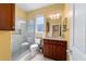 Bright bathroom with a glass-enclosed shower, modern fixtures, and dark wood cabinetry at 6865 Sw 97Th Terrace Rd, Ocala, FL 34481