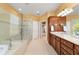 A view of the bathroom with double vanity and a glass enclosed shower at 6865 Sw 97Th Terrace Rd, Ocala, FL 34481