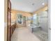 Bathroom featuring a glass shower, a soaking tub, and granite countertops at 6865 Sw 97Th Terrace Rd, Ocala, FL 34481