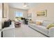 Bright room featuring neutral walls, a sofa, desk and large window at 6865 Sw 97Th Terrace Rd, Ocala, FL 34481