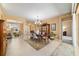Elegant dining room with a traditional table set, chandelier, and seamless access to the living spaces at 6865 Sw 97Th Terrace Rd, Ocala, FL 34481