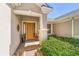 Inviting front entrance with a solid door, side windows, and potted plants adding to the curb appeal at 6865 Sw 97Th Terrace Rd, Ocala, FL 34481