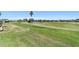 Green golf course landscape with trimmed lawns and small pond in a well-maintained community at 6865 Sw 97Th Terrace Rd, Ocala, FL 34481