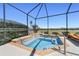Beautiful inground hot tub with tile accents and metal handrail inside of a screened patio at 6865 Sw 97Th Terrace Rd, Ocala, FL 34481