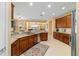 A kitchen showcasing granite countertops, wood cabinets and stainless steel appliances at 6865 Sw 97Th Terrace Rd, Ocala, FL 34481