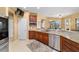 Fully equipped kitchen featuring stainless steel appliances, granite countertops, and bar seating at 6865 Sw 97Th Terrace Rd, Ocala, FL 34481