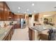 Spacious kitchen featuring granite countertops, wooden cabinets, and stainless steel appliances at 6865 Sw 97Th Terrace Rd, Ocala, FL 34481