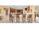 Spacious kitchen with bar seating, stainless steel appliances, and access to dining and living areas at 6865 Sw 97Th Terrace Rd, Ocala, FL 34481