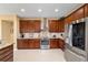 A view of the kitchen featuring wood cabinets, stainless steel appliances, and tile flooring at 6865 Sw 97Th Terrace Rd, Ocala, FL 34481