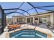 View of pool and spa with lounge seating, plus outdoor seating and dining area, all screened in at 6865 Sw 97Th Terrace Rd, Ocala, FL 34481