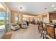 Open-concept living area with tile flooring, comfortable seating, and access to an outdoor patio at 6865 Sw 97Th Terrace Rd, Ocala, FL 34481