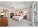 A view of the main bedroom with wood furniture and a ceiling fan at 6865 Sw 97Th Terrace Rd, Ocala, FL 34481