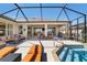 Screened-in patio with an outdoor seating area and a sun deck with a small spa pool at 6865 Sw 97Th Terrace Rd, Ocala, FL 34481