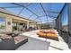 Covered patio showing outdoor seating and a sun deck with a small spa pool, with a view of the back yard at 6865 Sw 97Th Terrace Rd, Ocala, FL 34481