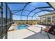 Relaxing screened-in pool area with a hot tub, covered lounge seating, and an amazing view of the green at 6865 Sw 97Th Terrace Rd, Ocala, FL 34481