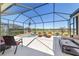 Screened lanai with a luxurious pool and lounge area, offering stunning views of the golf course at 6865 Sw 97Th Terrace Rd, Ocala, FL 34481