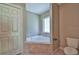 Bathroom featuring a separate tub, a toilet, and a closet for storage at 7082 Sw 131St Loop, Ocala, FL 34473