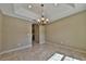 Charming dining room with decorative chandelier, neutral walls, and arched entryway at 7082 Sw 131St Loop, Ocala, FL 34473