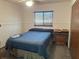 Cozy bedroom with carpet flooring and a window offering natural light at 9140 Sw 103Rd Ln, Ocala, FL 34481