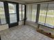 Sunroom featuring tile flooring, multiple windows, and a glass-topped table at 9140 Sw 103Rd Ln, Ocala, FL 34481