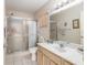 Bathroom featuring a glass shower, a vanity with a sink, and patterned wallpaper at 9581 Sw 85Th Ave # D, Ocala, FL 34481