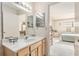 Well-lit bathroom with light-colored vanity, white countertop, and view into the Primary bedroom at 9581 Sw 85Th Ave # D, Ocala, FL 34481