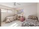 Cozy bedroom with two twin beds, ceiling fan, and natural light from the windows at 9581 Sw 85Th Ave # D, Ocala, FL 34481