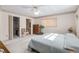Bright bedroom with a walk-in closet, dresser, and comfortable queen-sized bed at 9581 Sw 85Th Ave # D, Ocala, FL 34481