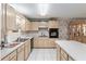 Traditional eat-in kitchen with tiled floor, white counters, and wooden cabinets at 9581 Sw 85Th Ave # D, Ocala, FL 34481