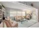 Bright living room with cozy seating, large windows, and floral wallpaper accents at 9581 Sw 85Th Ave # D, Ocala, FL 34481