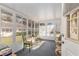 Relaxing sunroom with many windows, two seating areas, and a view of the outdoors at 9581 Sw 85Th Ave # D, Ocala, FL 34481