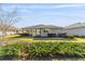 A serene backyard featuring lush greenery and a well-kept lawn, ideal for relaxation at 9974 Sw 88Th Loop, Ocala, FL 34481