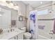 Charming bathroom with tub, shower, and decorative shower curtain at 9974 Sw 88Th Loop, Ocala, FL 34481