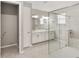 Modern bathroom with double vanity, framed mirrors, and frameless glass shower at 9974 Sw 88Th Loop, Ocala, FL 34481