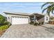 Charming home with well-kept lawn, lovely landscaping, and paved driveway leading to the two-car garage at 9974 Sw 88Th Loop, Ocala, FL 34481