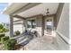 Covered front porch with a paved area, outdoor seating, and stylish exterior lighting fixtures at 9974 Sw 88Th Loop, Ocala, FL 34481