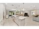 Bright kitchen island features granite countertops, stainless steel appliances, and pendant lighting at 9974 Sw 88Th Loop, Ocala, FL 34481