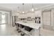 Bright kitchen with white cabinets, stainless steel appliances, granite island, and bar seating at 9974 Sw 88Th Loop, Ocala, FL 34481