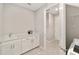 Bright laundry room with white cabinetry, sink, and modern hardware at 9974 Sw 88Th Loop, Ocala, FL 34481