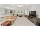 Comfortable living room with neutral tones, abundant natural light, and sliding door to a scenic outdoor view at 9974 Sw 88Th Loop, Ocala, FL 34481