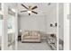 Cozy office space with neutral colors, a comfortable couch, a ceiling fan, and a serene atmosphere at 9974 Sw 88Th Loop, Ocala, FL 34481