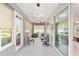 Bright sunroom with comfortable seating areas and windows, perfect for relaxation at 9974 Sw 88Th Loop, Ocala, FL 34481