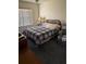 Bedroom featuring a comfortable bed, neutral paint, blinds, and carpet flooring at 10 Hickory Loop, Ocala, FL 34472